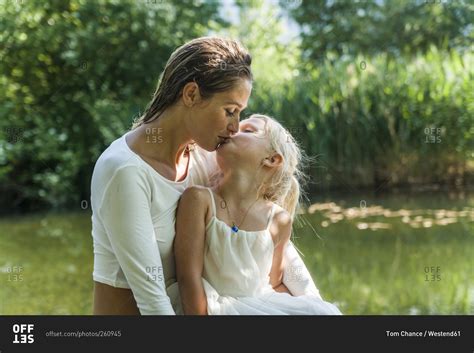 Mother And Babe Kissing At A Lake Stock Photo OFFSET