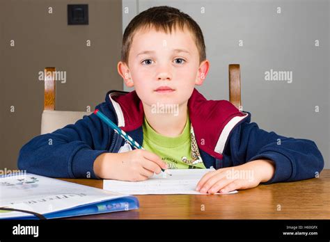 Boy Doing Homework In A Living Room Stock Photo Alamy