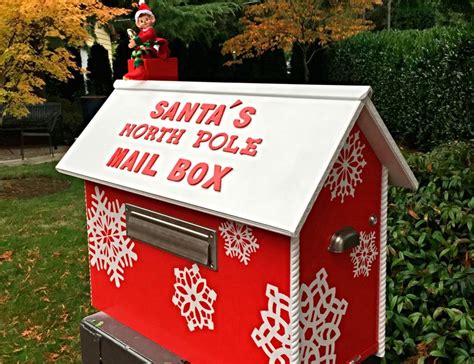 A Santas North Pole Mail Box Is Decorated With Snowflakes And An Elf