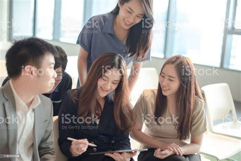 Asian Colleagues Discussing In Conference Room Stock Photo Download