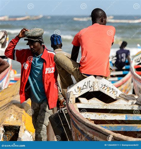 Unidentified Senegalese Man Sits On The Edge Of The Boat On The
