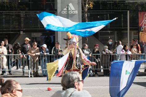 people in traditional clothes waving argentinian flag in hispanic day parade in new york city