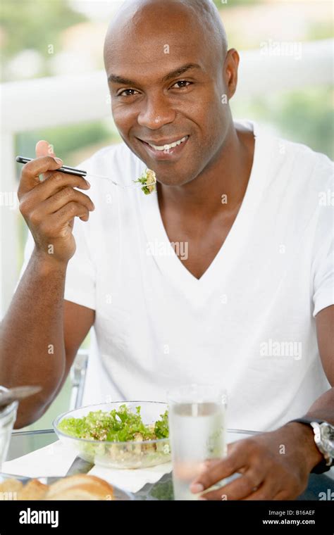 African American Man Eating Salad Stock Photo Alamy