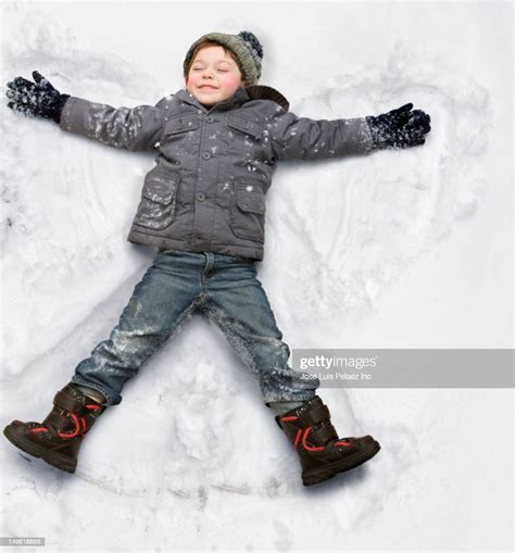 Caucasian Boy Making Snow Angel High Res Stock Photo Getty Images