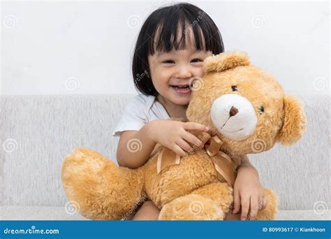 Happy Asian Chinese Little Girl Hugging A Teddy Bear Stock Image