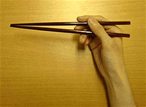 First, pick up a single chopstick, sandwiching it between your thumb and your index finger, as you would a pen. How to Hold the Chopsticks - An Introduction to Japanese Food - Cookbook - Kids Web Japan - Web ...