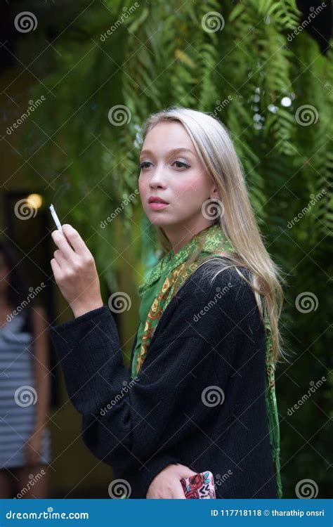 Portrait Of A Beautiful Young Woman Smoking Cigarettes Stock Photo