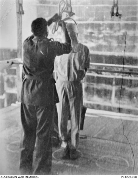 A Hangman Placing A Noose Over The Hooded Head Of A Convicted Japanese