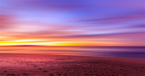 Wallpaper Id 220108 A Beach With A Scenic Purple And Orange Sunset