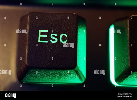 Makro Closeup Of Isolated Green Illuminated Esc Key On Computer