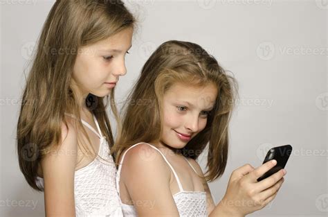 Two Young Girls Taking A Selfie With The Mobile Phone 1247676 Stock