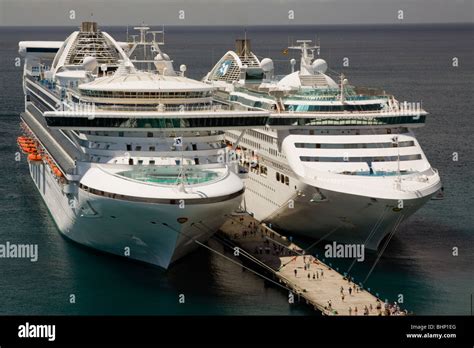 Two Cruise Ships Docked Side By Side At The Same Pier With Passengers In Grenada Caribbean