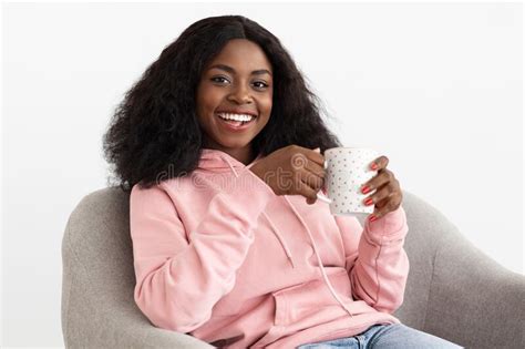 positive attractive black lady chilling alone at home drinking coffee stock image image of