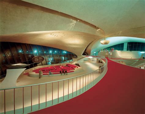 The Interior Of A Modern Building With Red Carpeting And Curved Walls