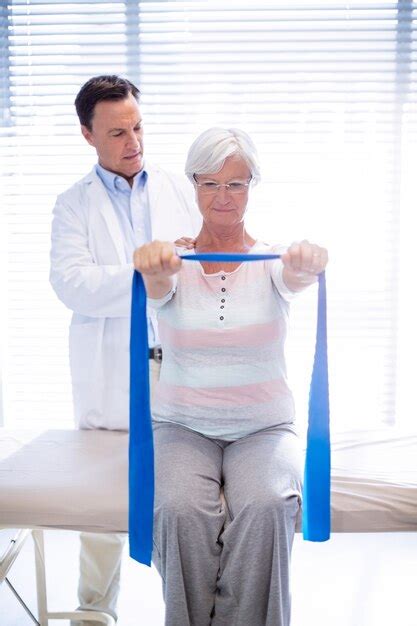 Premium Photo Male Physiotherapist Giving Shoulder Massage To Senior Woman