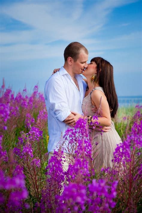 Romantic Kiss Among Purple Flowers Stock Photo Image Of Close