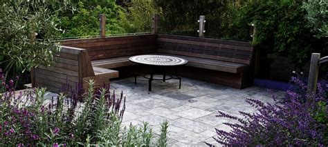 Bespoke Hardwood Seating With Travertine Paving Garden Design