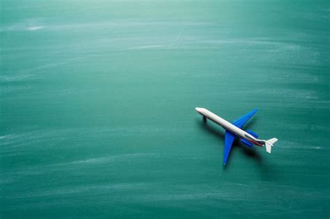 Premium Photo Toy Airplane Over Chalkboard Background