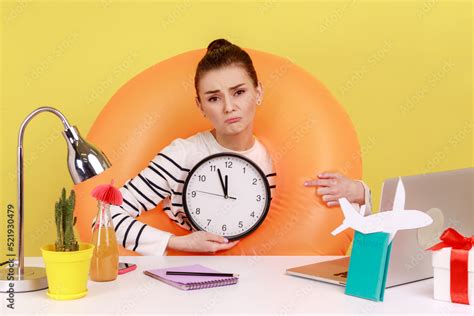 Sad Upset Woman In Rubber Ring On Neck Sitting At Workplace With Laptop Showing Wall Clock Has