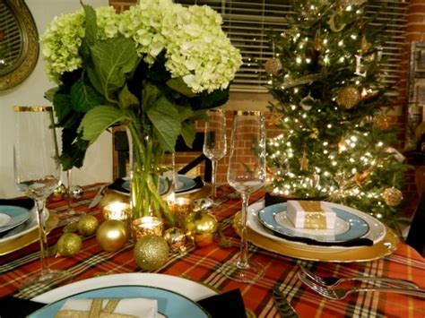 A Table Set For Christmas Dinner With Plates Silverware And Flowers In