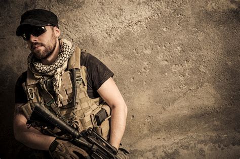 Portrait Of Modern Mercenary Soldier Looking Worried With Assault Rifle