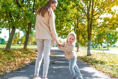 Woman Mother Walks Holds Hand Of Little Boy Son Autumn In City Walk