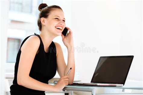 Businesswoman Is Talking On The Phone And Taking Notes Stock Image