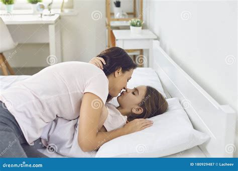 Happy Mother S Day Mother Hugs Babe Gives A Kiss While Lying On A White Bed In The Morning