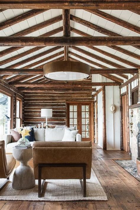Beneath A White Plank Vaulted Ceiling Accented With Rustic Wood Beams
