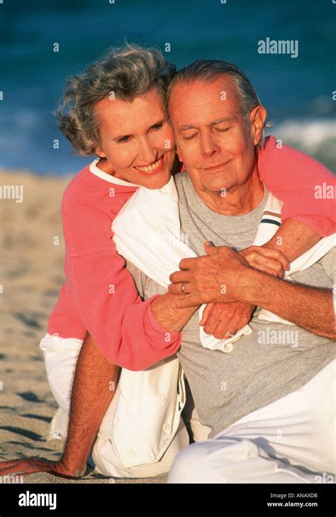 Affectionate Older Couple On Beach Stock Photo Alamy