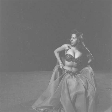 An Old Photo Of A Woman In A Belly Dance Outfit With Her Hands On Her Hips