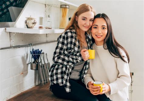 Free Photo Romantic Young Lesbian Couple Standing In The Kitchen