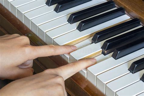 Girl S Hands Two Fingers Holding Pressed Keys On A Piano Stock Image