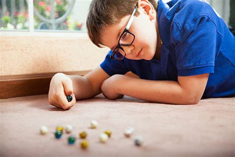 Little Kid Playing With Marbles Stock Photos Pictures And Royalty Free