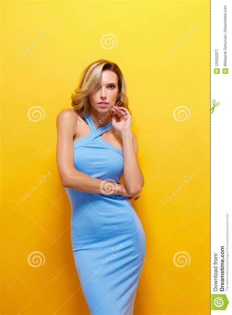 Beautiful Blonde Model In Blue Dress Posing At Camera Stock Image