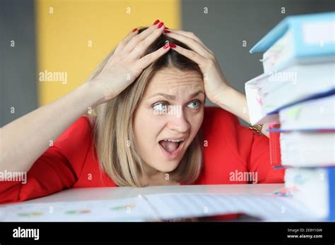 Woman Holding Her Head In Front Of Many Paper Folders Stock Photo Alamy