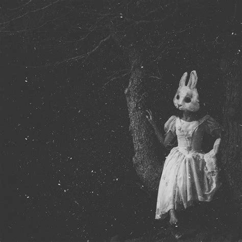 A Creepy Rabbit In A Dress Standing Next To A Tree