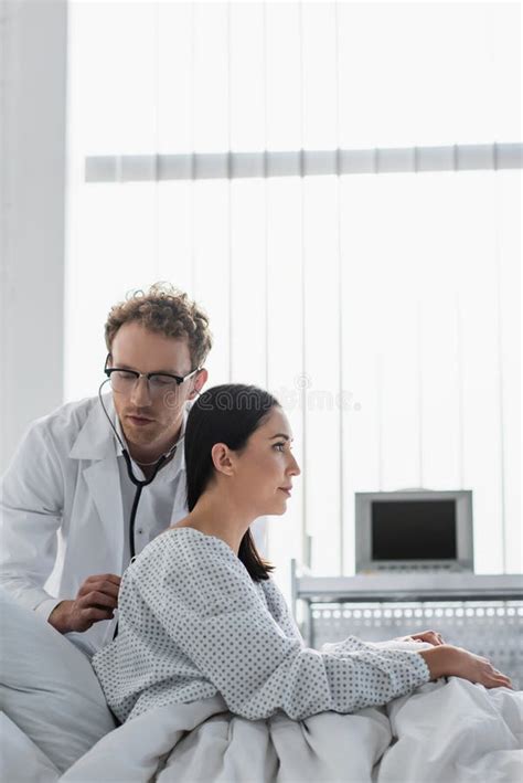 Curly Doctor In Glasses Examining Brunette Stock Image Image Of Ward