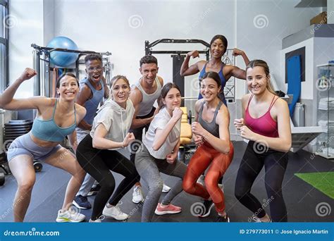 Multicultural Group Of Friends At Gym Flexing Muscles And Smiling For