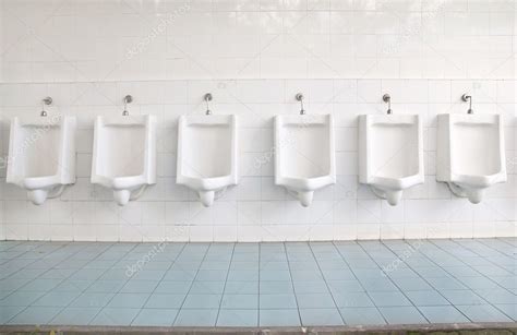 A Row Of Urinals In Tiled Wall In A Public Restroom — Stock Photo