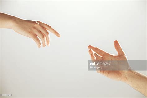 Hands Reaching Towards Each Other Bildbanksbilder Getty Images