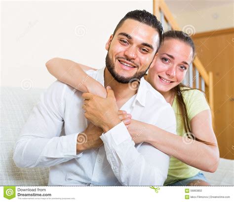 Pair Smiling And Embracing Indoors Stock Photo - Image of family, excited: 56863802