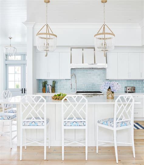 Coastal Kitchen With White Rattan Counter Chairs And Sea Blue Subway Backsplash Tile Via
