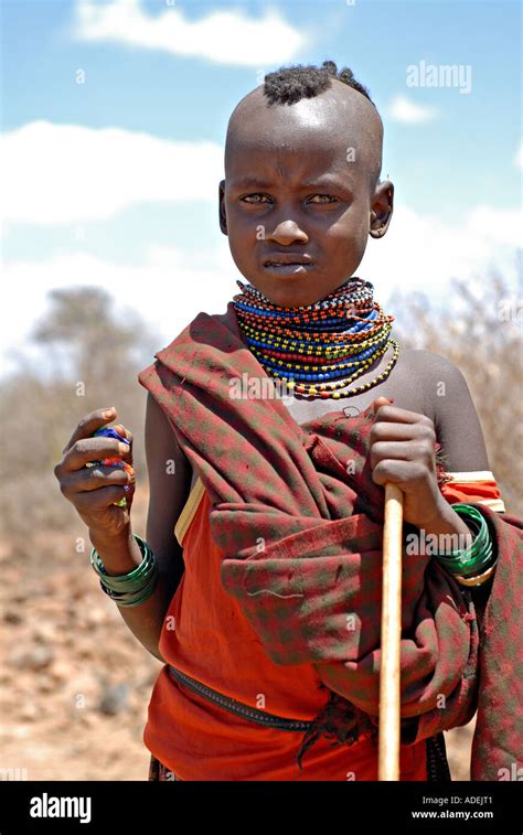 Little Turkana Boy Wearing Typical Tribal Hairstyle And Bead Ornaments