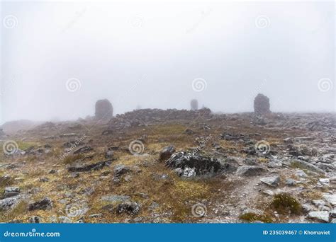 Small Built Stone Towers Among Stones With Moss In The Foggy Landscape