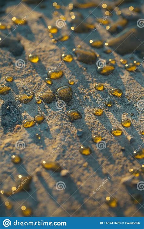 Water Or Rain Drops On Gray Ground Surface Stock Photo