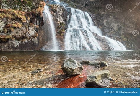 Beautiful Wide Waterfall With A Swimming Hole In The Foreground In The