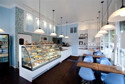 The other prominent area of the shop is the huge white terrazzo counter in the middle of the shop used for ordering of the desserts, putting all the equipment and coffee machine and also divide some space of the counter to be the counter bar. Stunning French Bakery Interior Design | Bakery shop design, Bakery interior