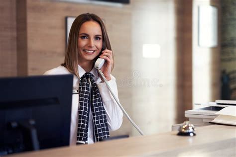 Receptionist Answering Phone At Hotel Front Desk Stock Photo Image Of
