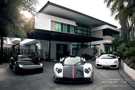 Two Sports Cars Parked In Front Of A House With The Words Those Who Say